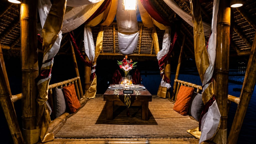Secluded private dining gazebo Ubud setup over tranquil fish pond at Tebasari Resto